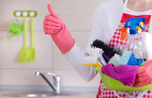 Cleaner using PPE while carrying out carpet cleaning