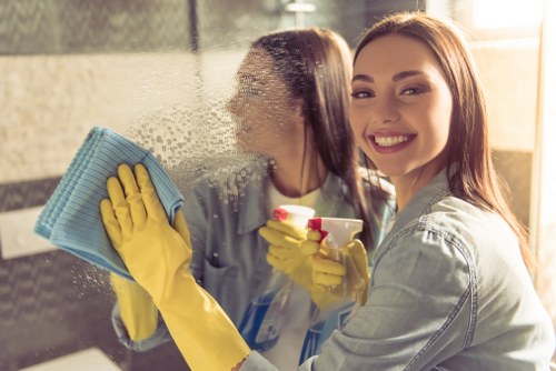 Cleaner maintaining a modern Canary Wharf apartment living area